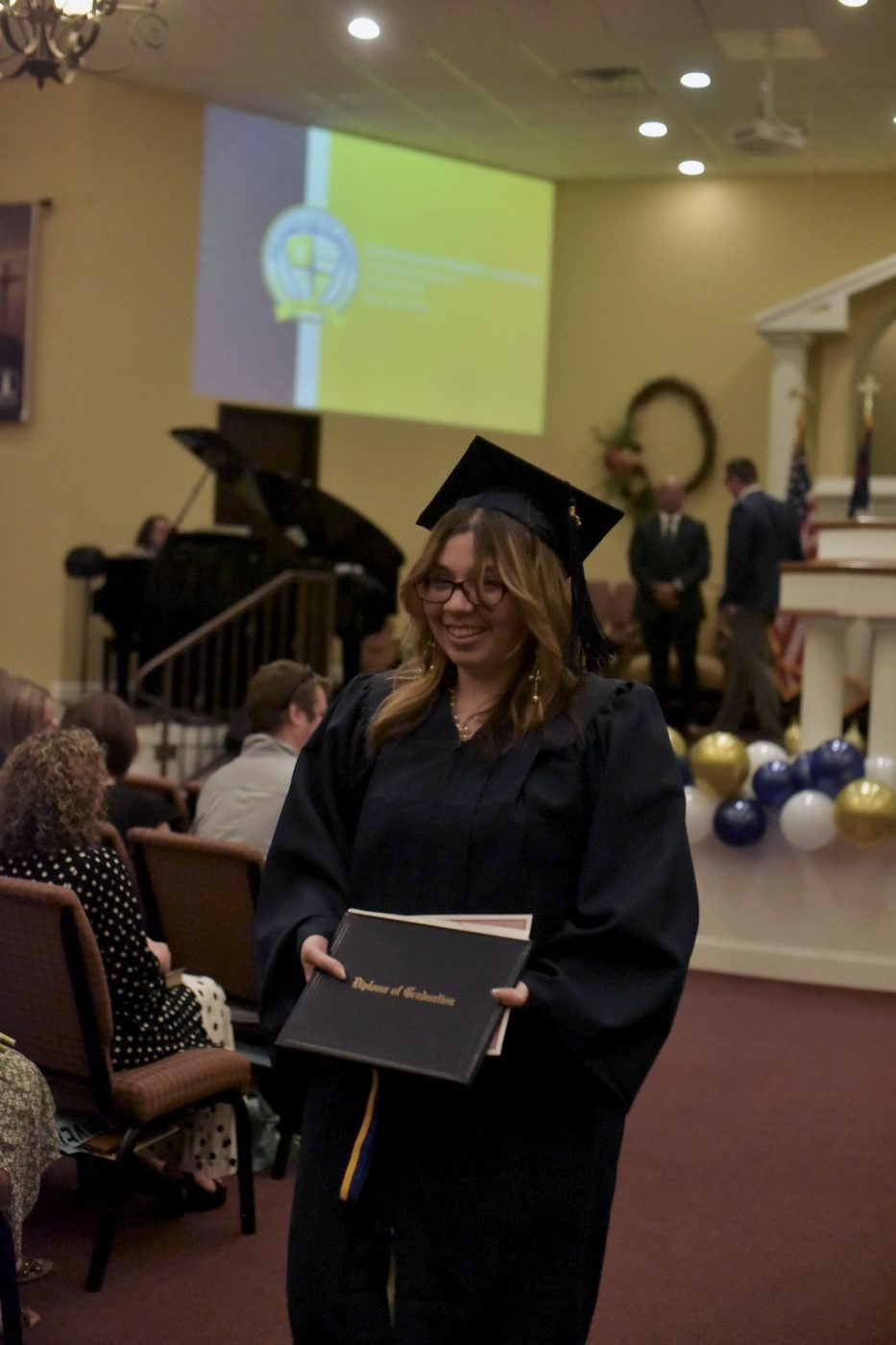 Ambassador Baptist Academy graduate holding diploma