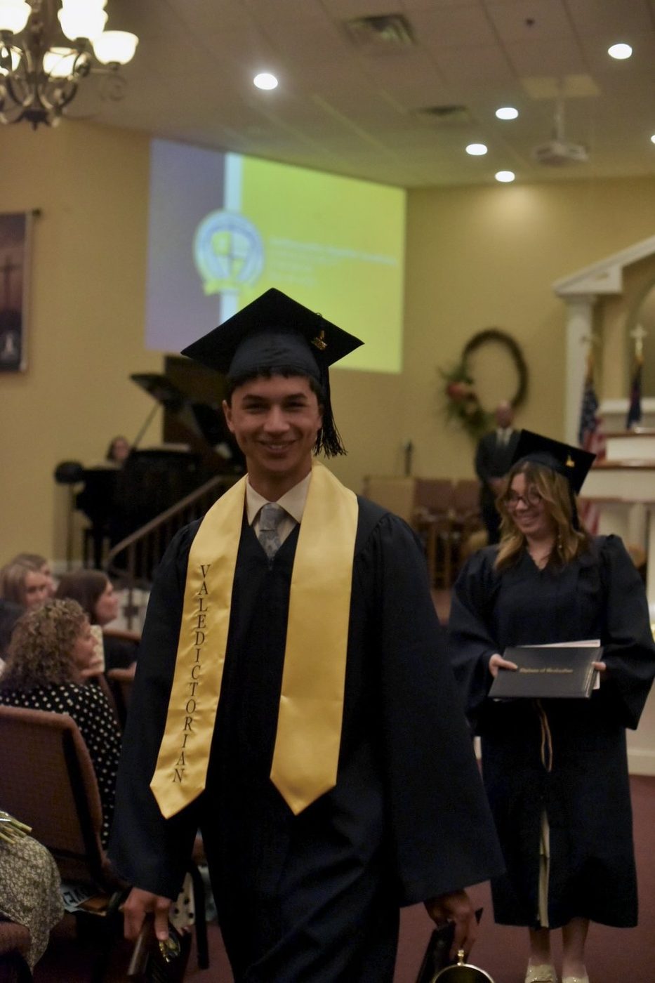 Ambassador Baptist Academy graduate on stage